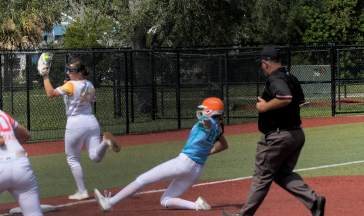 Hailey sliding feet first toward the base